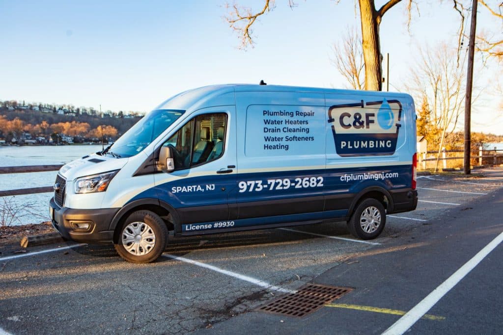 C&F Plumbing service truck with company branding parked in front of a residential home in Sparta, NJ.